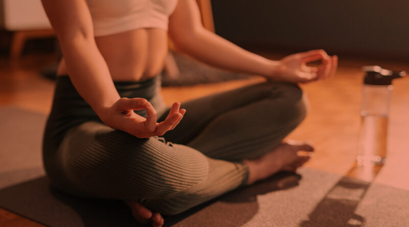 Mulher praticando yoga em casa