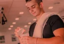 Jovem preparando shake de suplementos para treinar.